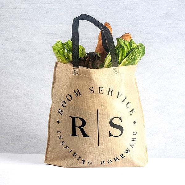 stitch-bonded non-woven material shopping bag with carrots and lettuce inside it