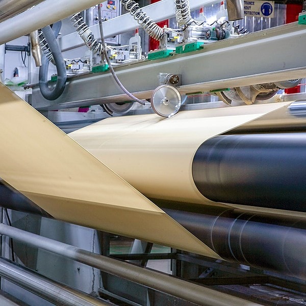 Stitch-bonded non-woven material rolling off the manufacturing equipment at Romatex